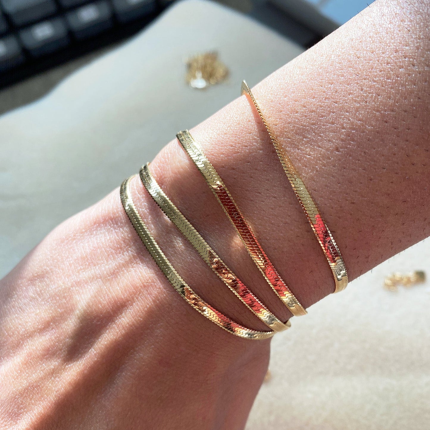 Model wearing the LucyKitty Gold Filled Mira Fine Herringbone Bracelet