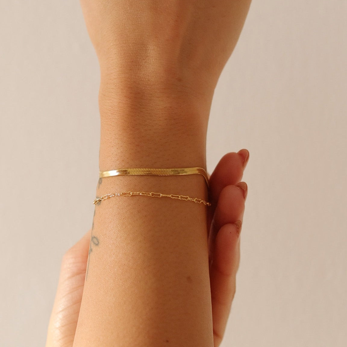 Model wearing the LucyKitty Gold Filled Zia Chain and Mira Fine Bracelets