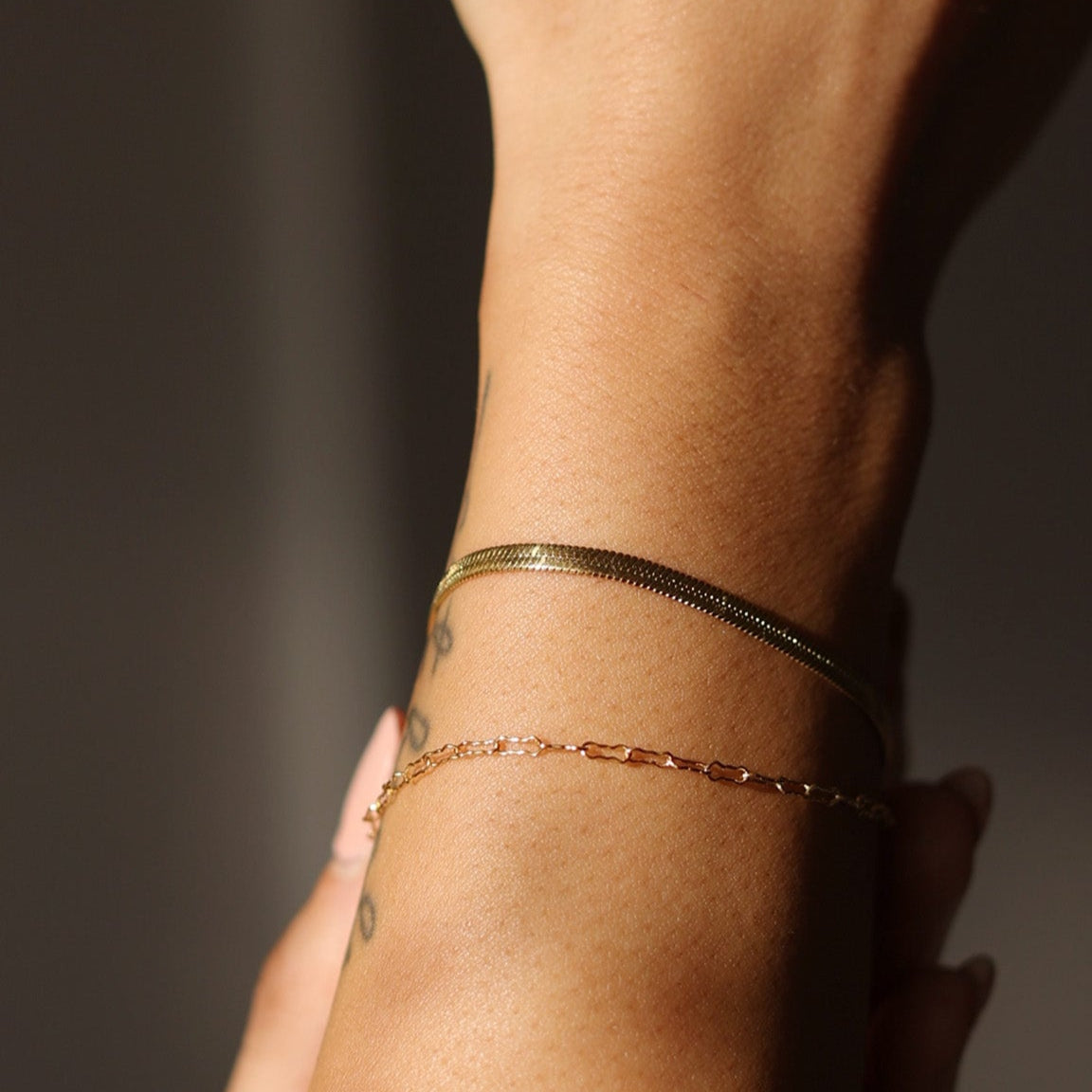 Model wearing the LucyKitty Gold Filled Zia Chain and Mira Fine Bracelets